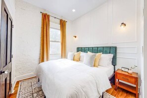 Welcome to our master bedroom! It comes with a king-sized bed with comfortable sheets and a cozy comforter to make sure you and your loved ones have a good night's sleep.