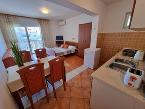 Kitchen area. Studio apartment - kitchen and living room with double bed