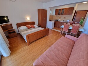 Living area. Studio apartment - living room with double bed and kitchen