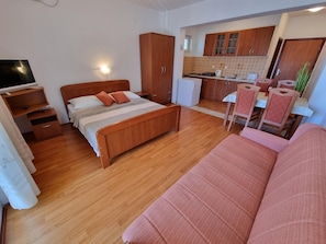 Living area. Studio apartment - living room with double bed and kitchen