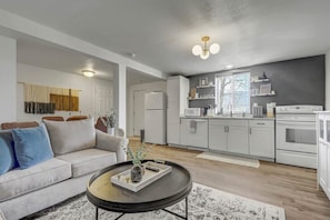 Our living room seamlessly connects to a fully-equipped kitchen and a roomy dining area. The expansive window bathes the space in ample natural light, allowing you to cook while keeping up with your favorite TV shows