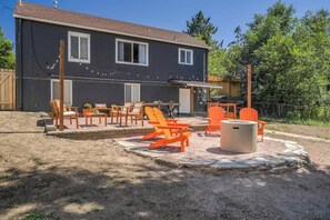 Gather 'round our communal fire pit nestled within a serene outdoor space.