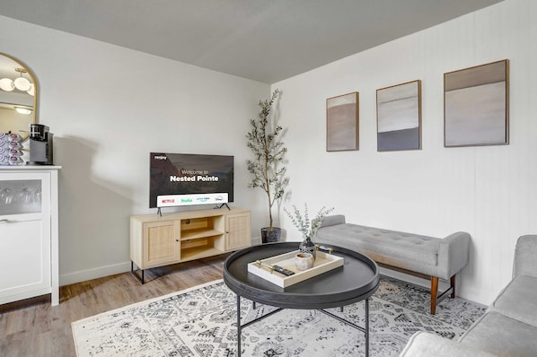 Welcome to our inviting living room, featuring a Smart TV, cozy couches, and an abundance of natural light pouring in through the windows – the perfect spot to unwind, watch a movie, and enjoy quality time with your family