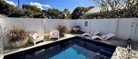 Privately fenced heated pool in front of house