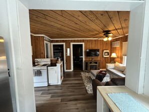 The entryway and breakfast bar lead to the living room and kitchen area.