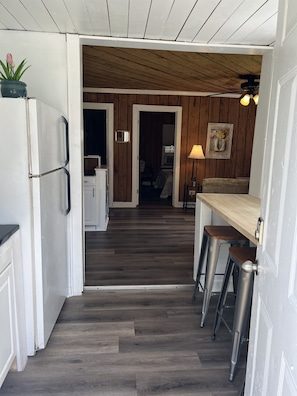 The entryway and breakfast bar lead to the living room and kitchen area.