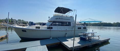 Entry to the boat is on the side or up a ladder on the back. Railings wrap around the entire yacht.