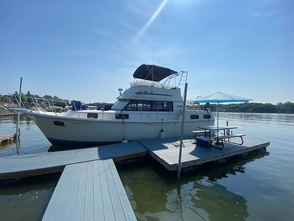 Entry to the boat is on the side or up a ladder on the back. Railings wrap around the entire yacht.