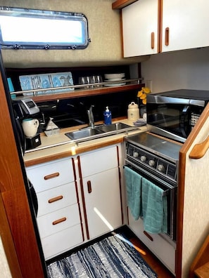 Cute little kitchen- fully stocked with all the essentials! The dual-coffee pot can make single serve k-cups, or a large pot of coffee for the whole crew. Standard coffee, sugar, and creamer provided.