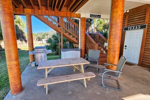 Ground level outdoor space includes picnic table and gas grill.