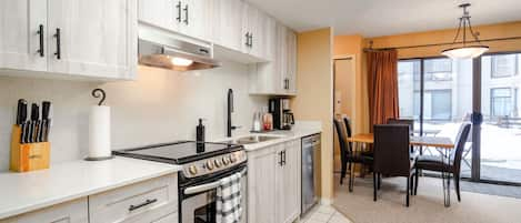 Once you first walk in to the suite you will enter through the kitchen area.   The kitchen has all of the essentials like an oven, fridge, dishwasher, and coffee maker.