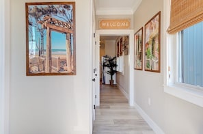 Entry hallway, laundry closet and guest utility closet to the left