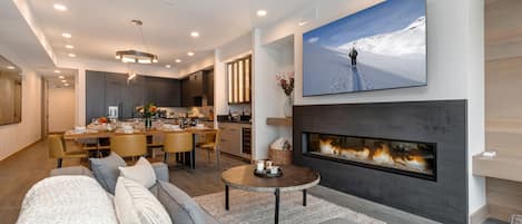 Living Room with sectional, Smart TV, gas fireplace, and private balcony access