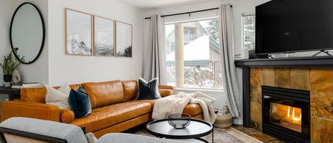 Living Room- Plenty of seating space is offered with the sectional and chairs centered around the TV and gas fireplace