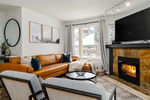 Living Room- Plenty of seating space is offered with the sectional and chairs centered around the TV and gas fireplace