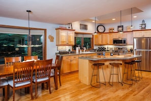 The open concept kitchen and dining room enable a fun atmosphere for all guests to enjoy