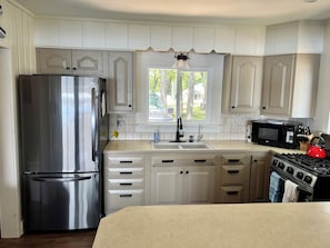 Kitchen with new stove and refrigerator. Reverse Osmosis drinking system