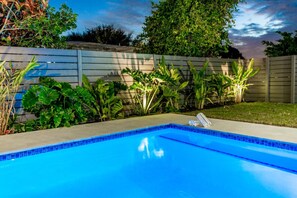 Private fenced pool with in-pool bench