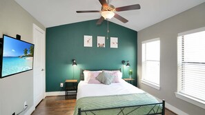 Bedroom on third floor with a queen-sized bed, TV