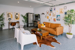Fun-filled garage turned game room, complete with an arcade and claw machine for endless entertainment.
