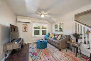 Bright cheerful living room with a mid-century-esque vibe! Mini split AC/Heat