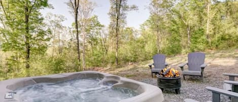 Relaxing hot tub and fire pit for roasting marshmallows, hot dogs, and summertime campfire stories.