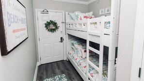 Entrance into The Crabby Shack! Freshly painted bunk beds that sleep 2. Look at those new comforter's. The colors are so bright and vibrant. 