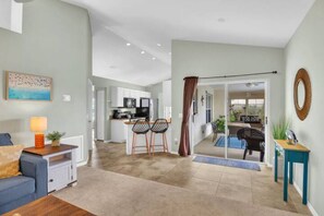 Living area with TV connected to kitchen