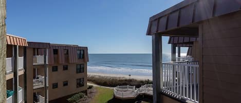 View from the back patio balcony of the beach and ocean.