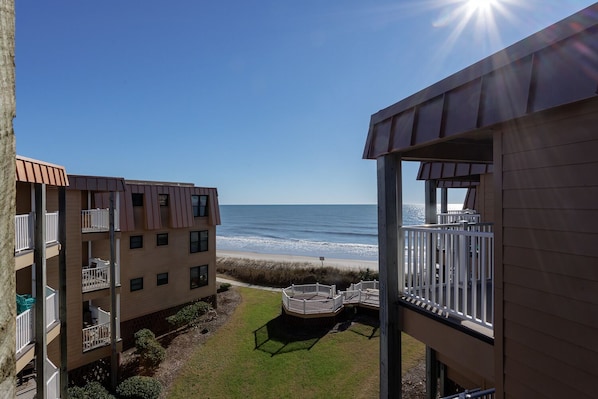 View from the back patio balcony of the beach and ocean.