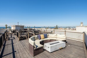 Roof Deck w/ Bay Views & Fire Pit, outdoor dining area, and propane BBQ grill