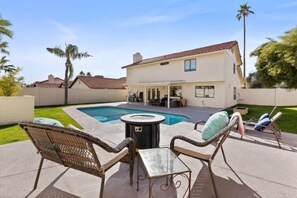 Oversized private walled backyard with large pool, fire pit & covered patio.