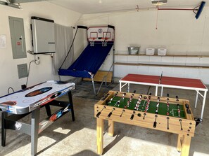 Garage game room with basketball, foosball, ping pong, air hockey, ring toss