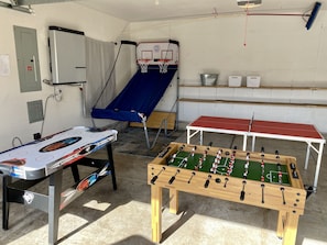 Garage game room with basketball, foosball, ping pong, air hockey, ring toss