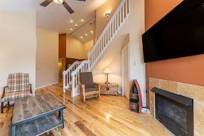 Living area offering cozy furnishings, a gas fireplace, and mounted TV.