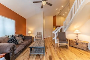 Living area offering cozy furnishings, a gas fireplace, and mounted TV.