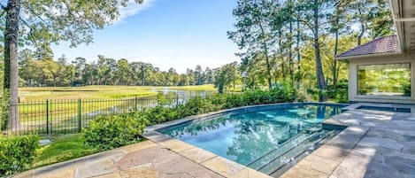 The backyard  features an in-ground swimming pool and whirlpool spa