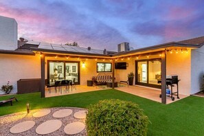 Covered patio with dining and outdoor living room with TV