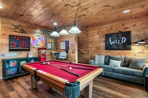 Unwind and have fun in the game room with a pool table, dart board, and classic games for all!