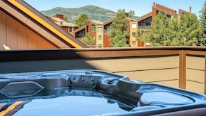 Peek the mountain tops from your private hot tub