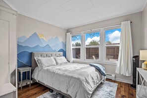 Full size memory foam guest room, blackout curtains, fan, clothes rack & shelves