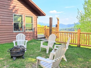 Fire pit in the side yard with comfortable seating and a view!