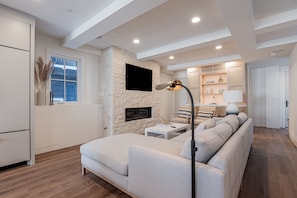 This room offers plush furnishings, a 50" TV and gas fireplace