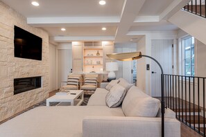 This room offers plush furnishings, a 50" TV and gas fireplace