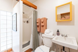 The private bathroom has a walk-in shower, quality toiletries, and fresh towels.