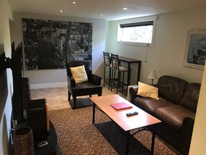 Living room with high top table and two comfortable stools