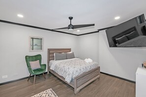 Queen size bed with a Smart TV
