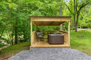 Gazebo on right side of cabin has hot tub steps from the stream with cafe lights!