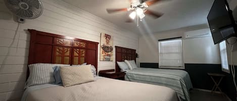 Dual queen beds with mini split ac unit, and TV