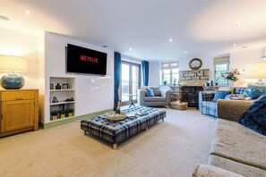 The spacious living room benefits from a 55-inch SMART TV with Netflix on the wall, plenty of space to sit down with family and friends in the evening, and a gorgeous log burner to keep warm in the evenings.